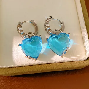 Close-up of elegant blue heart crystal hoop earrings with sparkling zircon accents