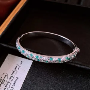 Elegant silver-tone bangle bracelet paved with mint green and clear zircon stones