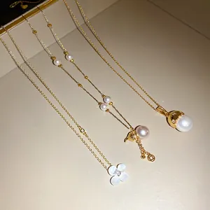 Detail view of 14k gold plated necklaces featuring elegant pearl and flower pendants