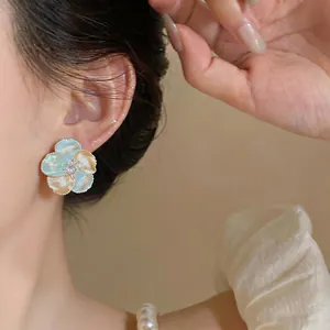 Elegant French style pastel blue and orange drip glaze flower stud earring on ear