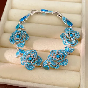 Detail of vintage-style flower bracelet with blue zircon and turquoise-toned stones