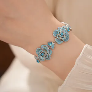 Detailed view of a vintage-style flower bracelet with turquoise stones and zircons