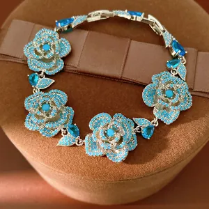 Vintage silver-tone bracelet with blue zircon flower charms and pear-cut accents