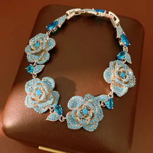Detailed view of turquoise flower bracelet with blue stones on a luxury jewelry box