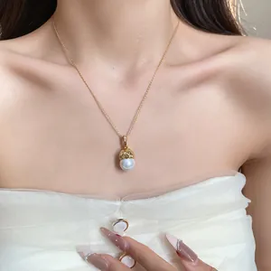 Detailed view of a 14k gold plated zircon flower pendant necklace on a model's neck