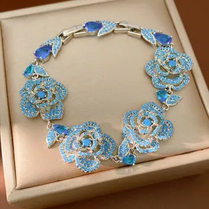 Exquisite detail of vintage silver bracelet featuring blue zircon hollow rose charms.