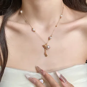 Detailed view of an elegant gold-plated gourd pearl pendant necklace on a female model