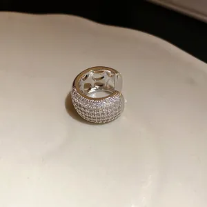 Macro view of a sparkling zircon ear cuff with hollow star pattern details