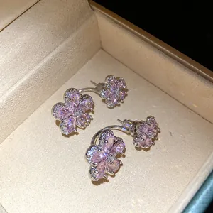 Close-up detail of pink zircon flower-shaped earrings displayed in a luxury jewelry box