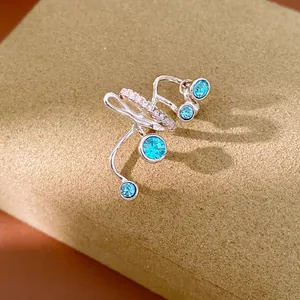 Detail view of silver multi-layer ear cuff featuring blue crystals and rhinestones