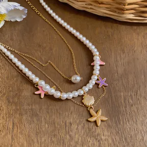 Detailed view of the layered pearl necklace with shell and starfish charms.