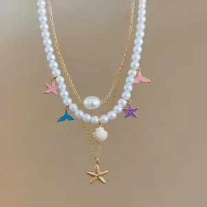 Close-up of multi-layered pearl necklace with colorful starfish and shell charms