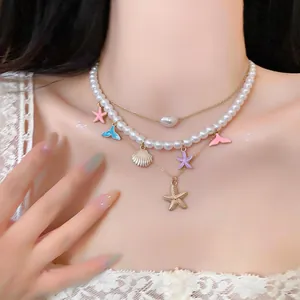 Close-up of beach-style layered necklace with shell, starfish charms and pearls