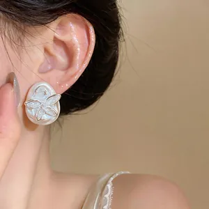Detailed view of an elegant butterfly zircon stud earring on a water-drop base