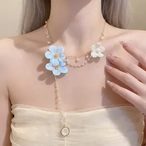 Elegant pearl beaded necklace with blue fabric flowers and long tassel for holiday style