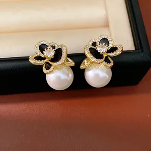 Elegant 14k gold plated floral earrings with micro-pave zirconia and white pearls.
