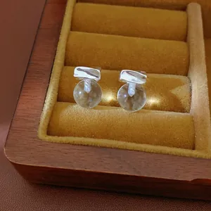 Minimalist silver needle stud earrings with clear round resin beads in a gift box