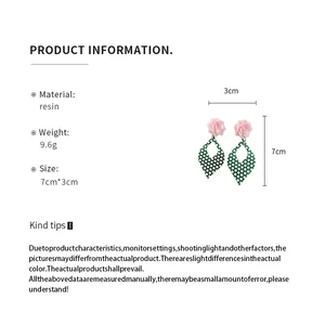 Detailed view showing resin flower and polka dot earrings with dimensions and material info.