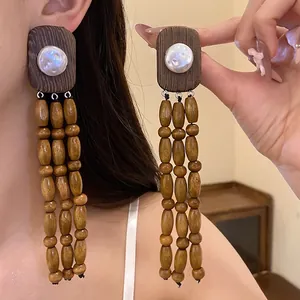 Elegant vintage style wooden tassel earrings featuring white pearls and 925 silver needles