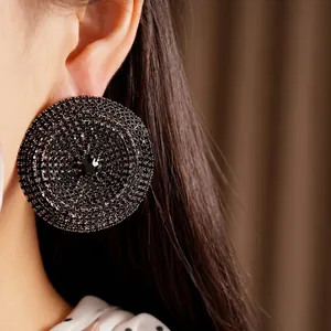 Pendientes de botón circulares grandes con cristales negros y diseño elegante