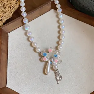 Iridescent beaded pearl necklace with floral pendant and elegant water drop tassel