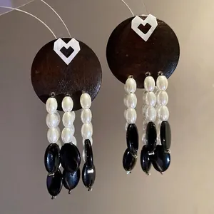 Vintage wood earrings with white hearts, pearl beads, and black stone tassels
