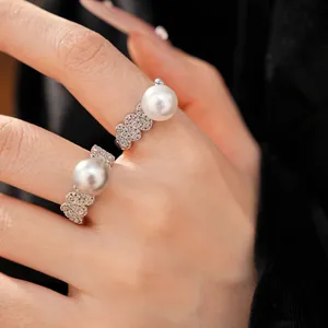 Close-up of elegant open ring with pave zircons and a large white pearl detail