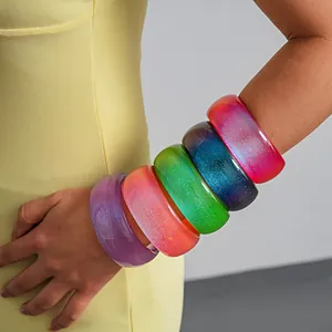Detail view of colorful translucent resin bangles with iridescent glitter shimmer