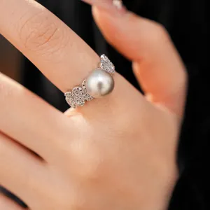 Close-up of zircon pavé geometric ring with a grey round pearl detail