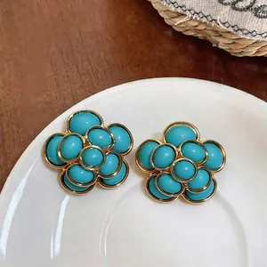 Elegant vintage French style flower stud earrings featuring turquoise resin and gold frames