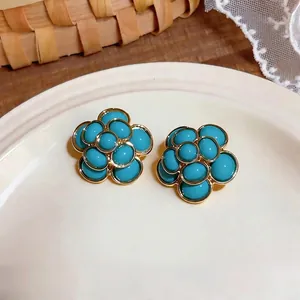 Vintage French style flower stud earrings with turquoise resin and gold-tone finish