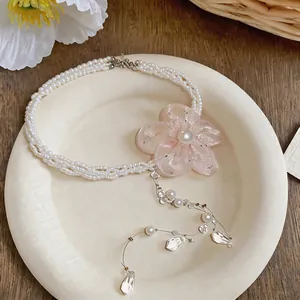 Detailed view of chiffon flower pearl necklace with teardrop crystal tassels
