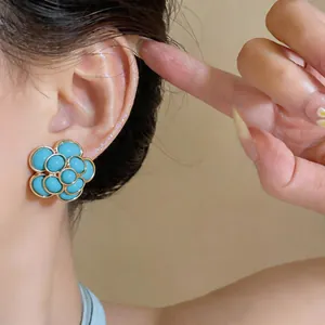 Macro view showing the elegant French vintage turquoise resin flower stud earrings
