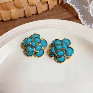 Vintage French style turquoise resin flower stud earrings with gold finish for women.