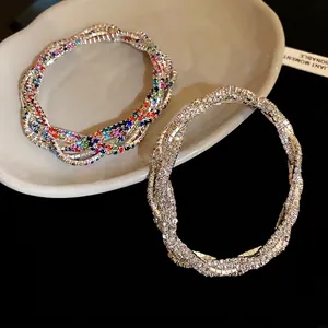 Elegant multi-layer twisted rhinestone bracelet with colorful and clear crystals on a tray