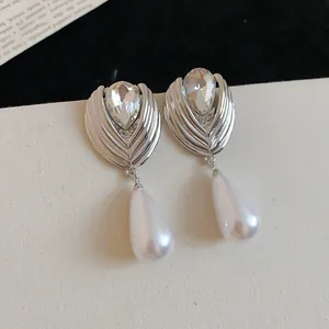 Detailed view of French style waterdrop pearl earrings with sparkling rhinestones