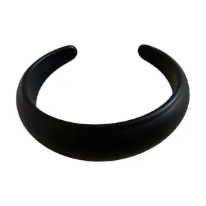 Minimalist black resin elliptical open bangle with a smooth matte finish for stylish women