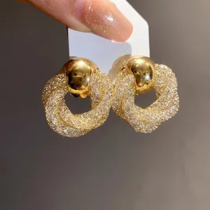 Vintage gold-plated twisted mesh hoop earrings featuring sparkling crystal pavé details