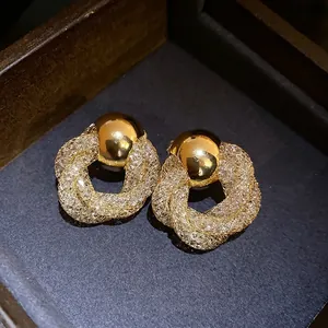 Elegant vintage gold mesh twisted flower stud earrings with a refined luxury finish.