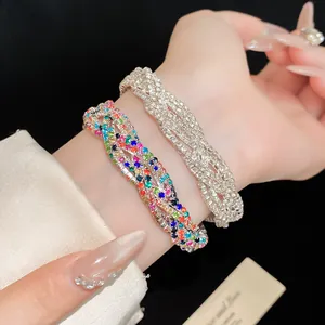 Close-up of multi-layer intertwined bracelets with sparkling colorful and clear rhinestones.