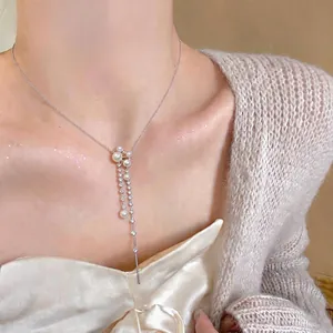 Elegant French style necklace featuring white pearls and sparkling zircons on a silver chain.