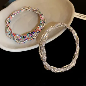 Close-up of sparkling multi-layer rhinestone wrap bracelets in silver and rainbow