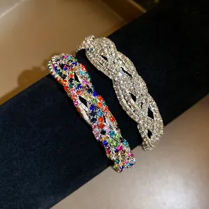 Detail of multi-layer braided rhinestone bracelets in clear and vibrant rainbow colors.