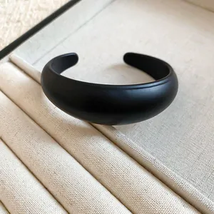 Detailed view showing the matte black resin finish of this oval open cuff bracelet jewelry