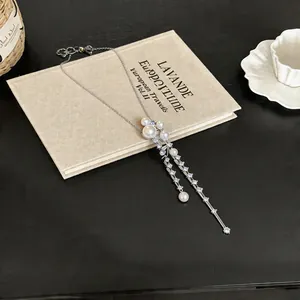 Close-up detail of French style pearl and zircon necklace on a vintage book backdrop.