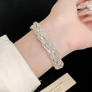 Close-up view of elegant silver-tone multi-layer twisted rhinestone bracelet on a model's wrist