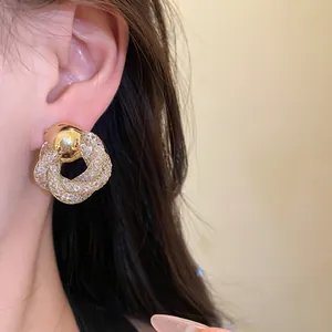 Close-up of elegant vintage gold mesh twisted flower stud earrings on model's ear