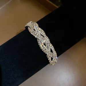 Close-up of a sparkling multi-layer twisted bracelet with full rhinestone inlay.