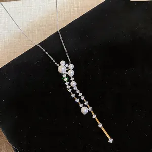 Close-up of elegant French style pearl and zircon necklace on black velvet background