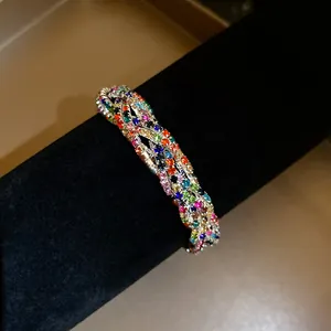 Close-up of a multi-layer wrap bracelet encrusted with vibrant colorful rhinestones